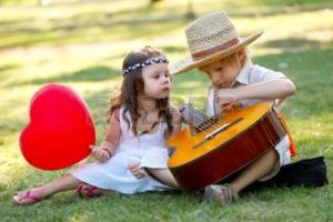 10778560-young-couple-with-guitar-on-grass-in-park